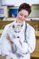 Portrait of woman vet holding a cute puppy