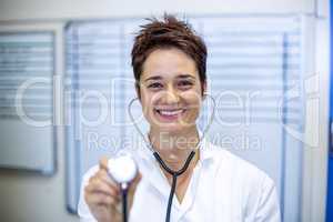 Portrait of woman vet smiling with a stethoscope on her ears