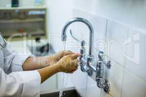 Close up on a vet washing his hands