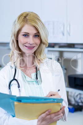 Portrait of woman vet holding some documents