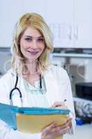 Portrait of woman vet holding some documents