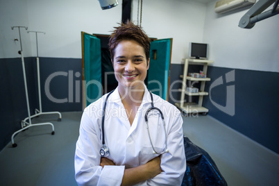 Portrait of woman vet smiling and posing with crossed arms