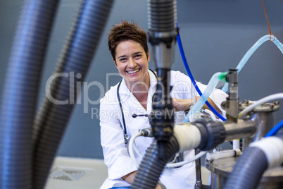 Woman vet smiling and posing behind medical machine