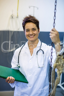 Portrait of woman vet smiling and holding documents