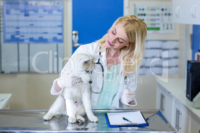 Woman vet smiling and looking a cute puppy