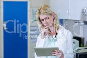 Portrait of woman vet studying a tablet