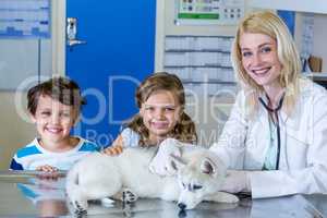 Portrait of woman vet and children smiling and posing with a cut