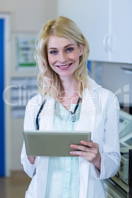 Portrait of woman vet smiling and holding a tablet