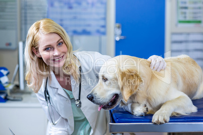 Woman vet smiling and posing with a dog