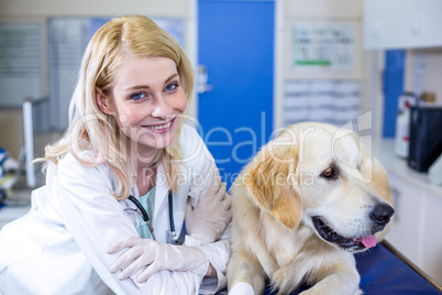 Woman vet smiling and posing with a dog