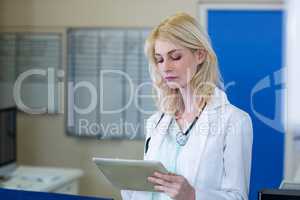 Portrait of concentrated woman vet using a tablet