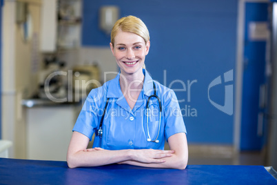 Portrait of woman vet smiling and posing with crossed arms