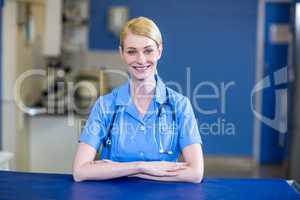 Portrait of woman vet smiling and posing with crossed arms