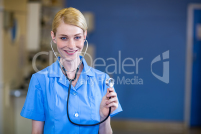 Portrait of woman vet smiling and having a stethoscope on her ea