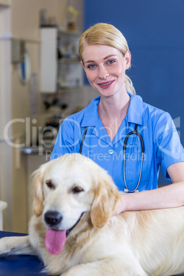Portrait of woman vet smiling and posing with a dog