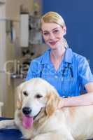 Portrait of woman vet smiling and posing with a dog