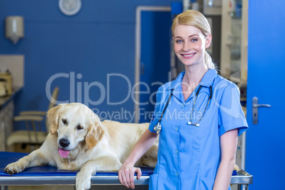 Smiling woman vet posing with a dog