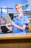 Portrait of woman vet working with her tablet computer