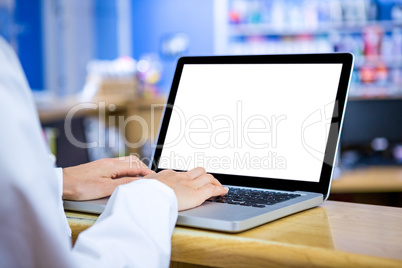 Close up of woman vet working with her laptop