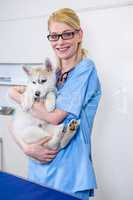 A woman vet bringing a dog