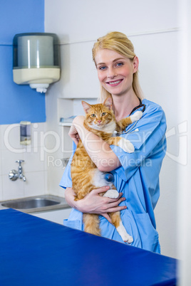 A woman vet bringing a cat