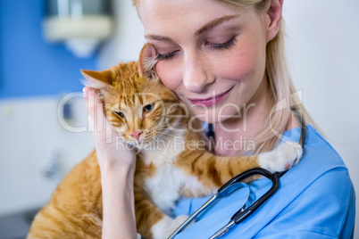 A woman vet petting a cat