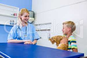 A woman vet talking with a little boy