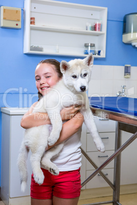 A little girl bringing a dog