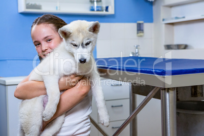 A little girl bringing a dog