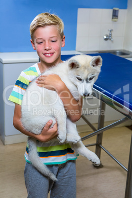 A little boy bringing a dog