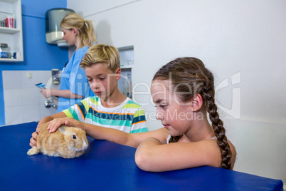 Children petting a rabbit