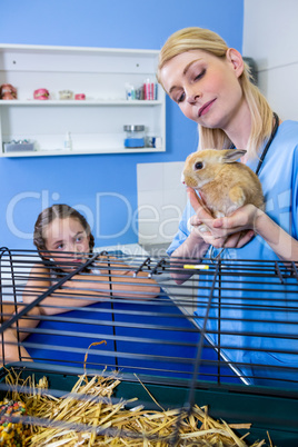 A woman vet bringing a rabbit