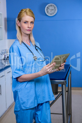 Portrait of woman vet working with her tablet computer