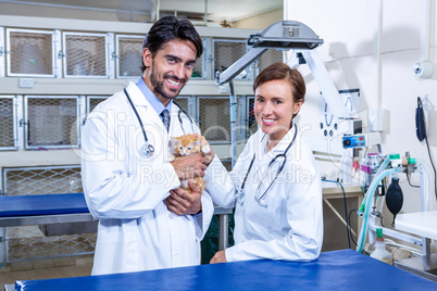 Vets looking at the camera holding a cat