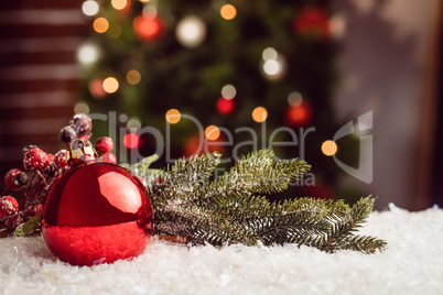 Composite image of Christmas bauble and holly