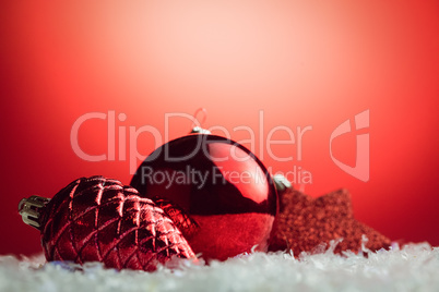 Composite image of Christmas bauble and pine cone