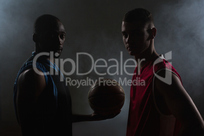 Two basketball player looking at the camera