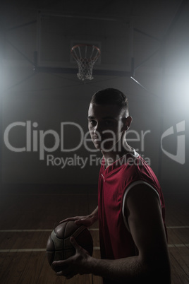 Portrait of basketball player holding a ball