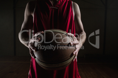 Close up on basketball player holding a ball