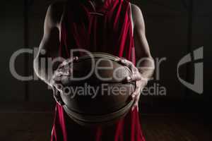 Close up on basketball player holding a ball