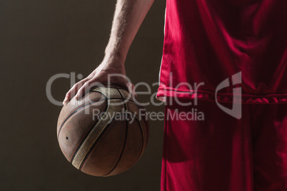 Close up on a basketball held by basketball player