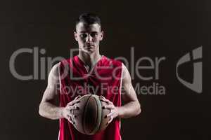 Portrait of basketball player holding a ball