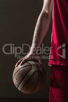 Close up on basketball held by basketball player