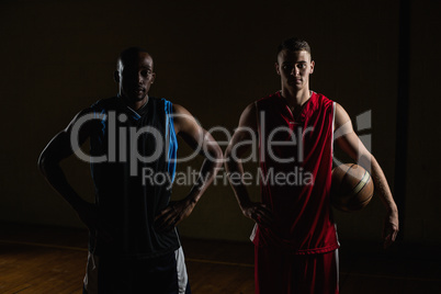 Portrait of basketball players posing with hands on hips