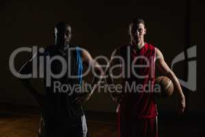 Portrait of basketball players posing with hands on hips