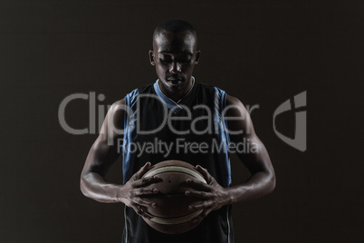 Portrait of basketball player holding a ball