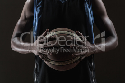 Close up on basketball player holding a ball