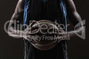 Close up on basketball player holding a ball