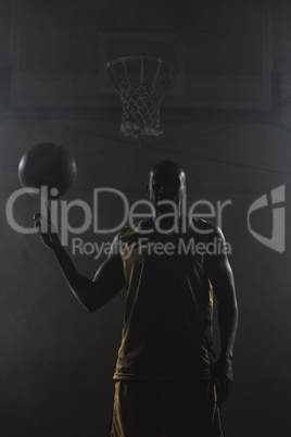 Basketball player turning the ball on his finger