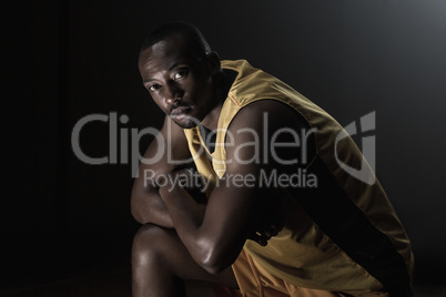 Portrait of basketball player looking the camera and posing with
